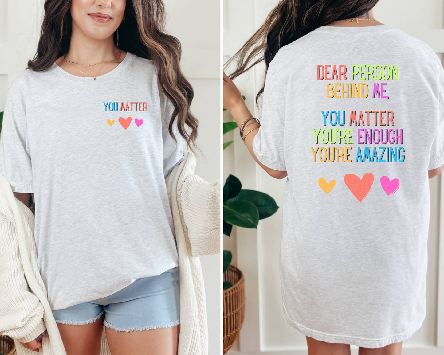 Person wearing a white t-shirt with motivational text and colorful hearts.
